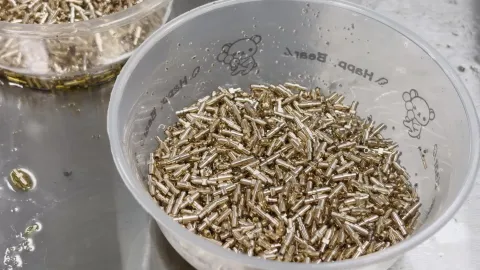 Collected brass connector contacts after Swiss-type machining; representative production batch