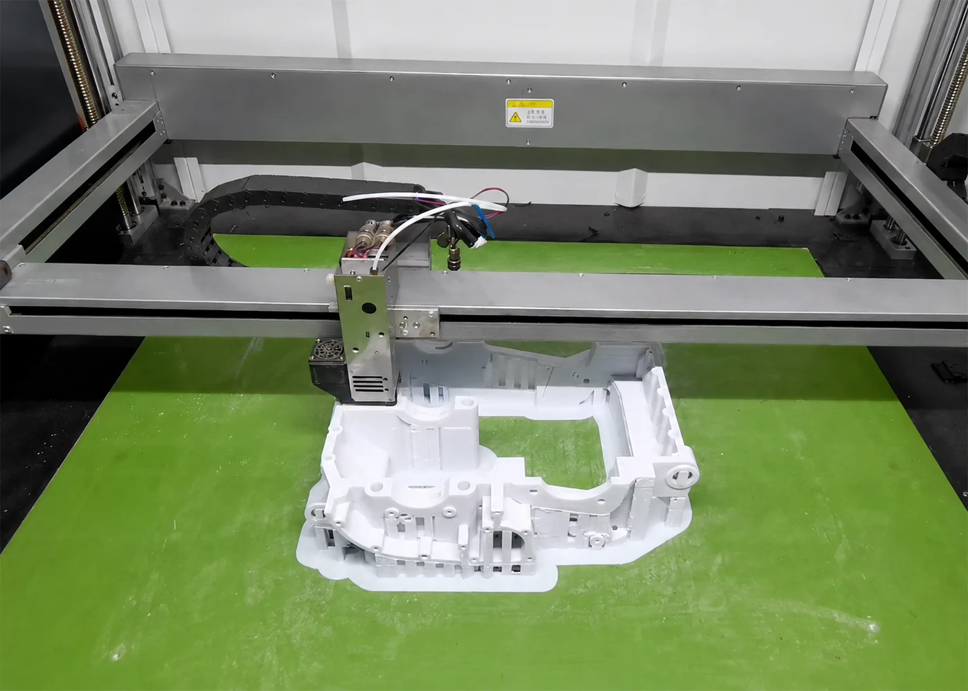 FDM heated nozzle depositing thermoplastic filament layer by layer