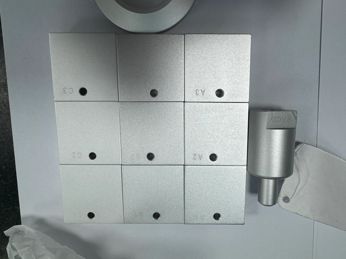 Nine surface trial coupons and a machined sample used to compare roughness and gloss during OUJI prototype development