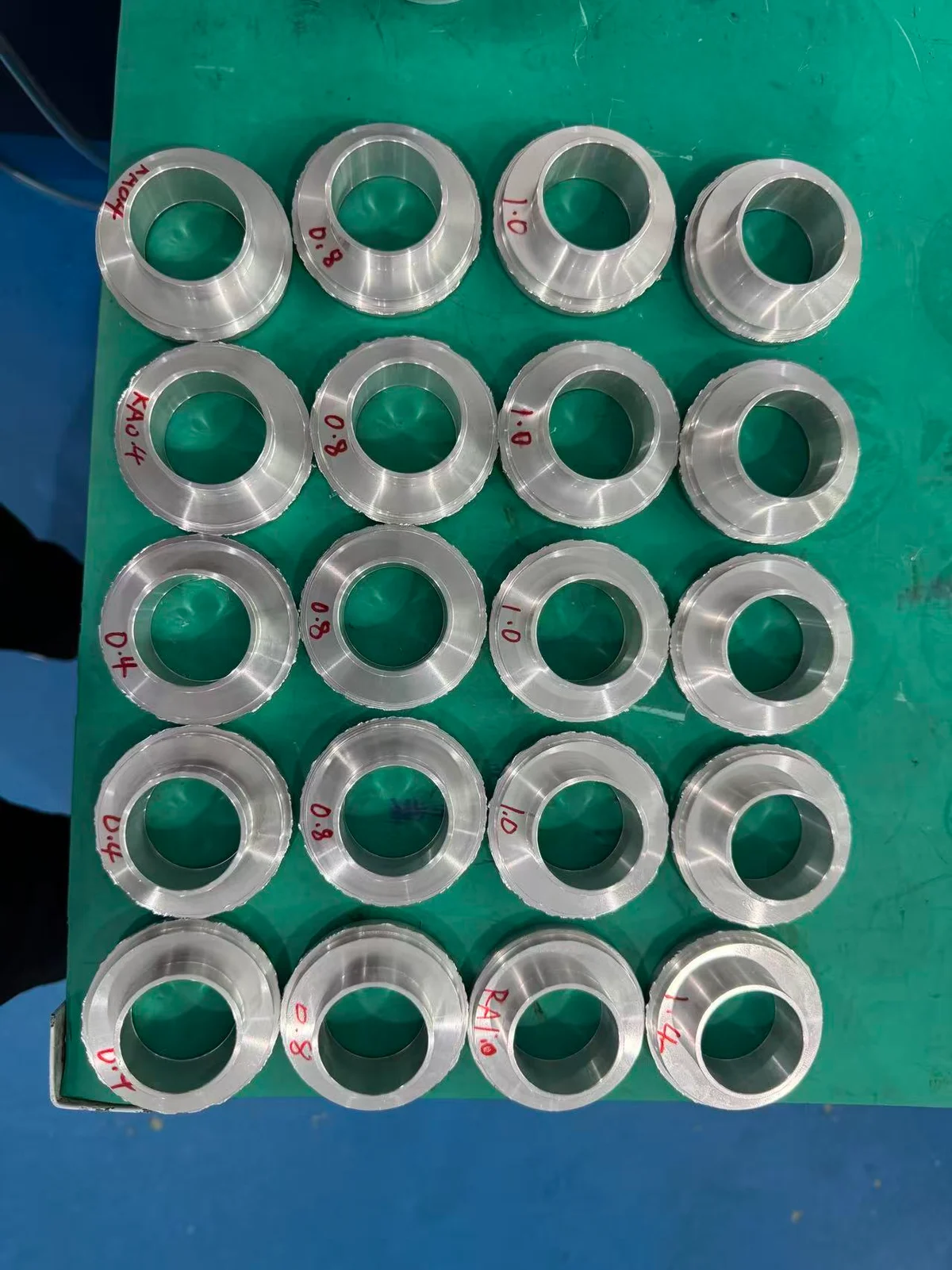 Turned 6082 aluminum test pieces marked with recorded Ra values of 0.4, 0.8, 1.0 and 1.4 micrometers