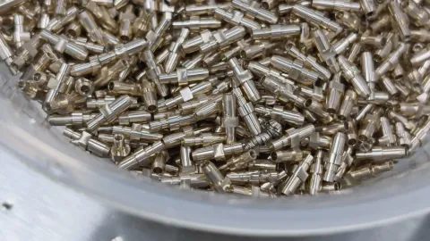 Turned brass connector contacts with stepped diameters, knurling and bores