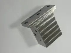Finished 304 stainless steel component with bores and machined features on multiple faces