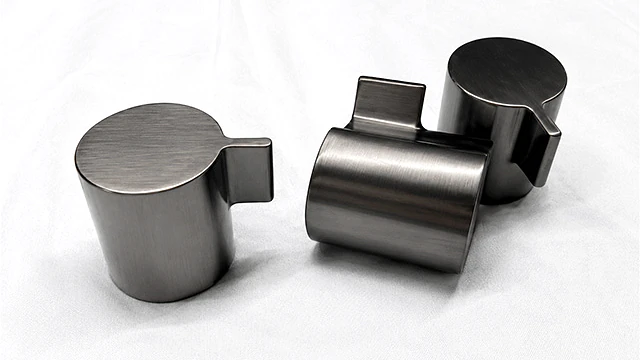 Machined metal parts displaying consistent brushed surface finishes