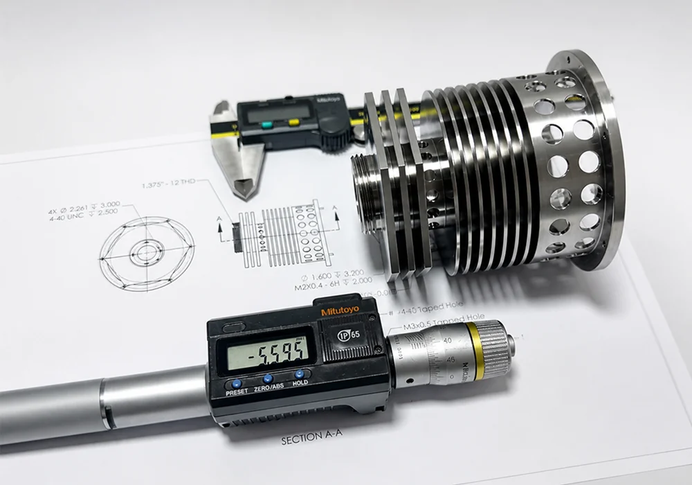 Custom CNC parts drawing review with machined parts and measuring tools